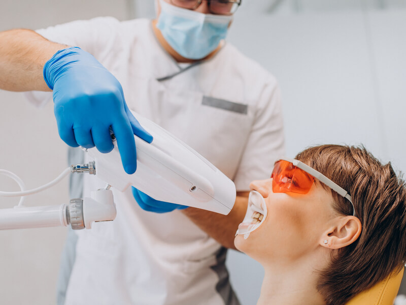 dentist providing teeth whitening service
