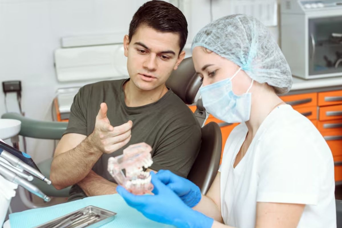 a dentist explaining dental crowns to a patient after root canal treatment.